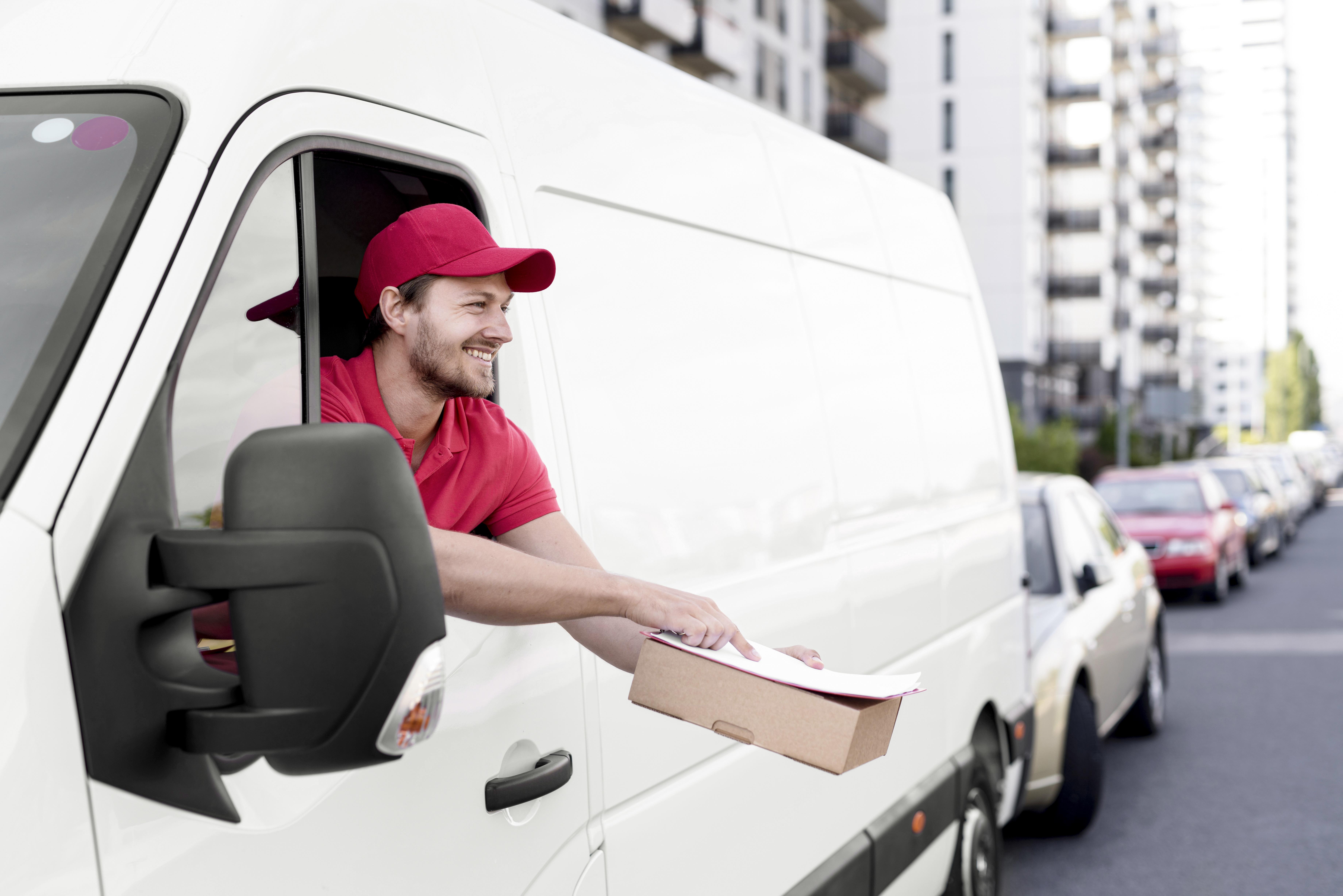 OT Transport driver handing a package to a customer — last mile delivery across Ontario